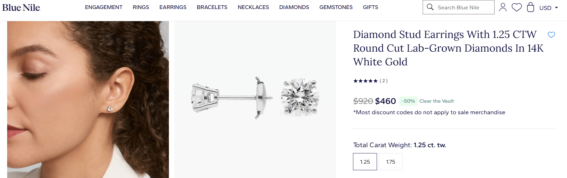 Round cut lab-grown diamond stud earrings in 14k white gold worn on ear